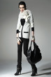 fashion model in autumn/winter clothes holding handbag posing