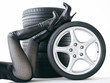 Sexy woman with High Heels playing with set of summer tyres