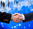 Shake hands with bussiness people standing on the globe