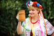 Portrait Happy Ukrainian woman with a wooden mug