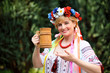 Portrait Happy Ukrainian woman with a wooden mug