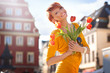 Happy woman with bunch of flowers