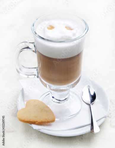 Photo: Glass of coffe with cookie on white plate Glass of coffe with cookie on white plate