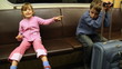 boy sleeps leaning to bag as well sister shows at him in train