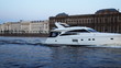 white boat sails along Neva River near shore of St. Petersburg