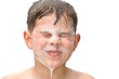 A boy swims in the bathtub