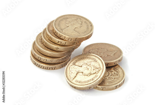 Photo: British, UK, pound coins on a plain white background. British, UK, pound coins on a plain white background.