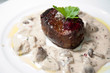 closeup of fresh grilled beef steak with cream mushroom sauce