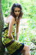 A young and sexy brunette Caucasian woman in a wild forest