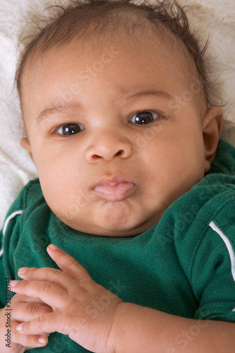 Photo: ethnic multiethnic mulatto Baby boy in green outfit ethnic multiethnic mulatto Baby boy in green outfit