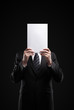 Business man in dark suit holding a blank sign