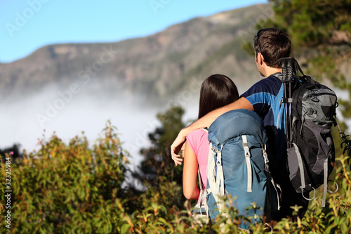 Photo: Couple hiking looking at view Couple hiking looking at view