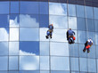 Workers washing a skyscraper windows Workers washing a skyscraper windows