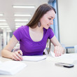 pretty, young college student in a library