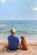 Man with his dog at the beach