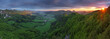 Green forest mountain at sunset with sun