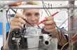 Student constructing electric vehicle prototype in vocational school