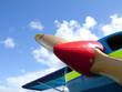 Blue sky over front of propellor airplane