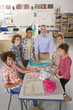 Smiling teacher and students in home economics class