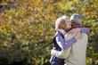 Photo: Romantic senior couple hugging in autumn park Romantic senior couple hugging in autumn park