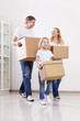 Parents and child with cardboard boxes