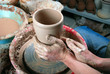 hands of a potter, creating an earthen jar on the circle