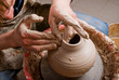 hands of a potter, creating an earthen jar on the circle hands of a potter, creating an earthen jar on the circle