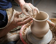 hands of a potter, creating an earthen jar on the circle hands of a potter, creating an earthen jar on the circle