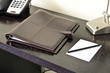Leather folder on desk in hotel room Leather folder on desk in hotel room