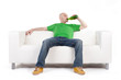 Photo: Man on sofa holding beer Man on sofa holding beer