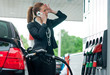 woman in gas station talking to mobile phone