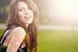 Portrait of a beautiful young woman in summer park.