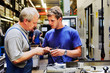 skilled workers controlling a workpiece