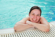 Young woman at the edge of a swimming pool