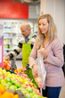 Young woman buying fruits