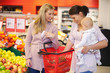 Foto: Mother carrying child with friend while shopping Mother carrying child with friend while shopping
