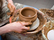 hands of a potter, creating an earthen jar on the circle hands of a potter, creating an earthen jar on the circle