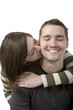 Young couple holding each other smiling on white background