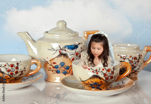 Photo: Miniature girl on tea party Miniature girl on tea party