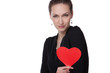 Portrait of young female holding heart shape
