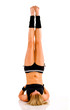 Young attractive Caucasian fitness woman doing gymnastics
