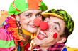 Two clown smiling isolated over a white background