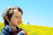 Little boy smells rapeseed flower Little boy smells rapeseed flower