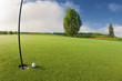 Golf ball near hole on golf course Golf ball near hole on golf course