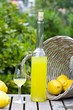 Limoncello and basket with lemons