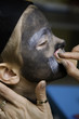 The boy makes a children's make-up The boy makes a children's make-up