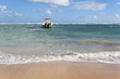 beach with boat on the sea and blue sky