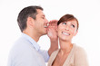 mann whispering woman