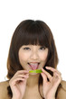 Portrait of young smiling woman licking lime