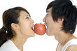 Couple biting an apple, isolated